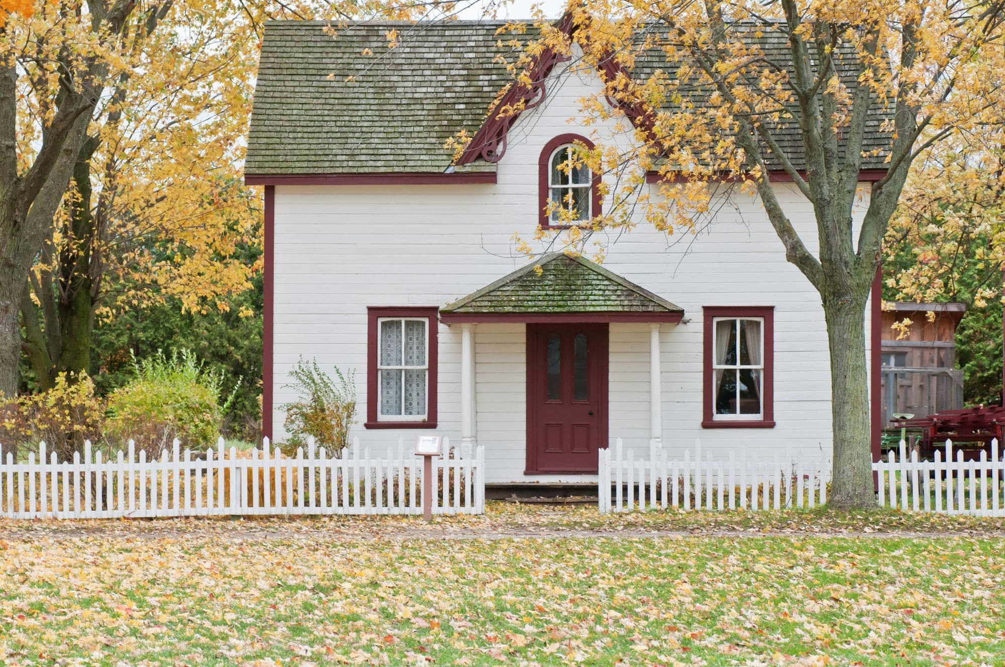 White house with a lawn and trees